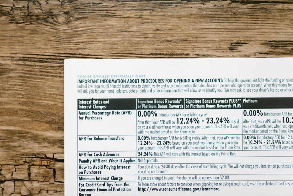 A detailed financial document listing interest rates on a textured wooden table.